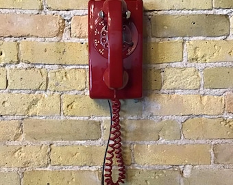 Bell System dial wall phone, red rectangular vintage phone with adjustable ringer volume. Works on most modern systems. Land line phone.