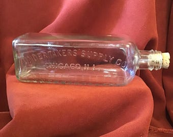 Undertaker’s Supply Co. Chicago, embossed blown glass bottle with cork stopper. Measurement lines Medical, chemical jar, funeral preparation