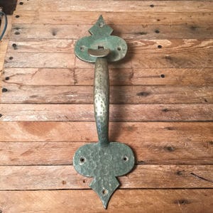 May include: A set of three ceramic mugs with a speckled, matte finish. The mugs are in shades of cream, light gray, and dark gray. Each mug has a simple, minimalist design and a rounded handle.