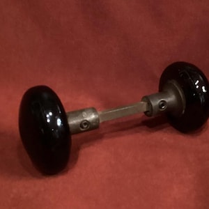 Vintage black ceramic doorknob set w (2 knobs, 2 screws, one spindle per set) polished restoration hardware. Replacement doorknob set.