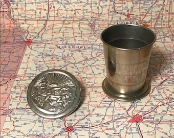 Collapsable metal drinking cup. Embossed lid, hunting scene with dogs. Travel cup with cap, chrome over brass.