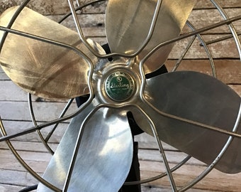 Sterling single speed four blade desk fan, open cage fan cover, cast iron base, classic pre fifties design, tilting fan head aluminum blades