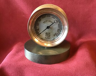 500 pound test gauge on stand, brass case, metal face with black markings by Ashcroft Mfg Co. Untested Steam Punk.