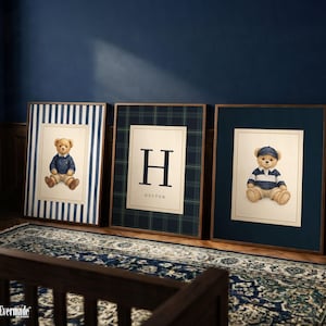 May include: Three framed prints featuring teddy bears and a monogram. The first print has a blue and white striped background with a teddy bear wearing a blue sweater. The second print has a plaid background with the letter "H" and the name "Hector". The third print has a teddy bear wearing a striped shirt and a hat.