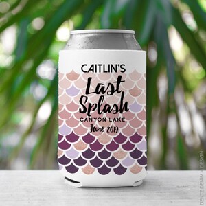 May include: A white can cooler with a mermaid scale pattern in shades of pink, purple, and rose gold. The text "CAITLIN'S Last Splash CANYON LAKE June 2019" is printed on the front. The cooler is designed to keep beverages cold.