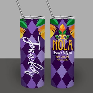 May include: Two purple and gold stainless steel tumblers with a Mardi Gras theme. One tumbler says "Jennifer" and the other says "NOLA Jenna's Dirty 30 New Orleans 10.02.2020".