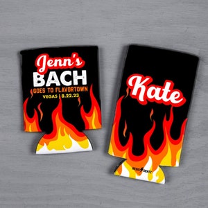 May include: Two black and red can coolers with flames. One cooler says "Jenn's Bach Goes to Flavortown Vegas | 8.22.23". The other cooler says "Kate".