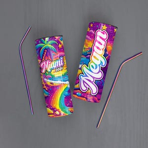 May include: Two stainless steel tumblers with colorful Miami-themed designs and matching straws. One tumbler features the word "Miami 2026" with a rainbow and palm tree. The other has the name "Megan" in a vibrant font.