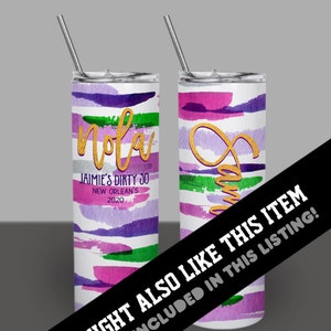 May include: Two stainless steel tumblers with a white background and colorful abstract brushstrokes in shades of purple, pink, and green. One tumbler has the word "Nola" in gold lettering and the text "JAIMIE'S DIRTY 30 NEW ORLEAN'S 2020". The other tumbler has a gold swirl design.