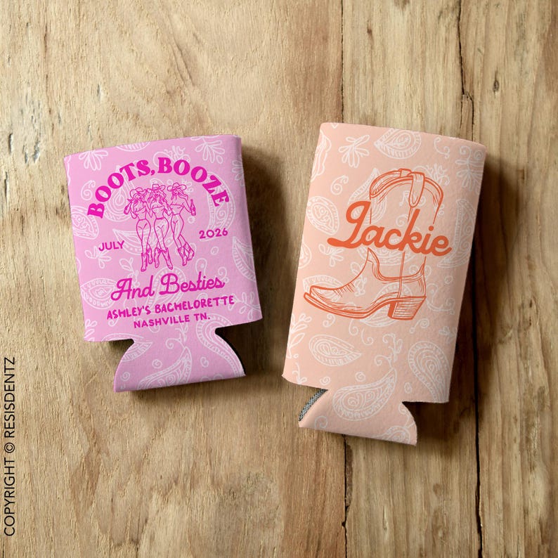 May include: Two pink and white can coolers. One cooler has a pink and white paisley pattern and the text "Boots, Booze" with a graphic of three women in cowboy boots. The other cooler has a pink and white paisley pattern and the text "Jackie" with a graphic of a cowboy boot.