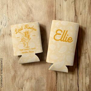 Personalized Last Rodeo bachelorette can cozies featuring a Western-themed design with a paisley background and a cowgirl in a martini glass. Customizable with names, event details, and available in multiple colors. Designed for slim and standard 12oz cans, these insulated drink holders are perfect for bachelorette parties, birthdays, and country music festivals.