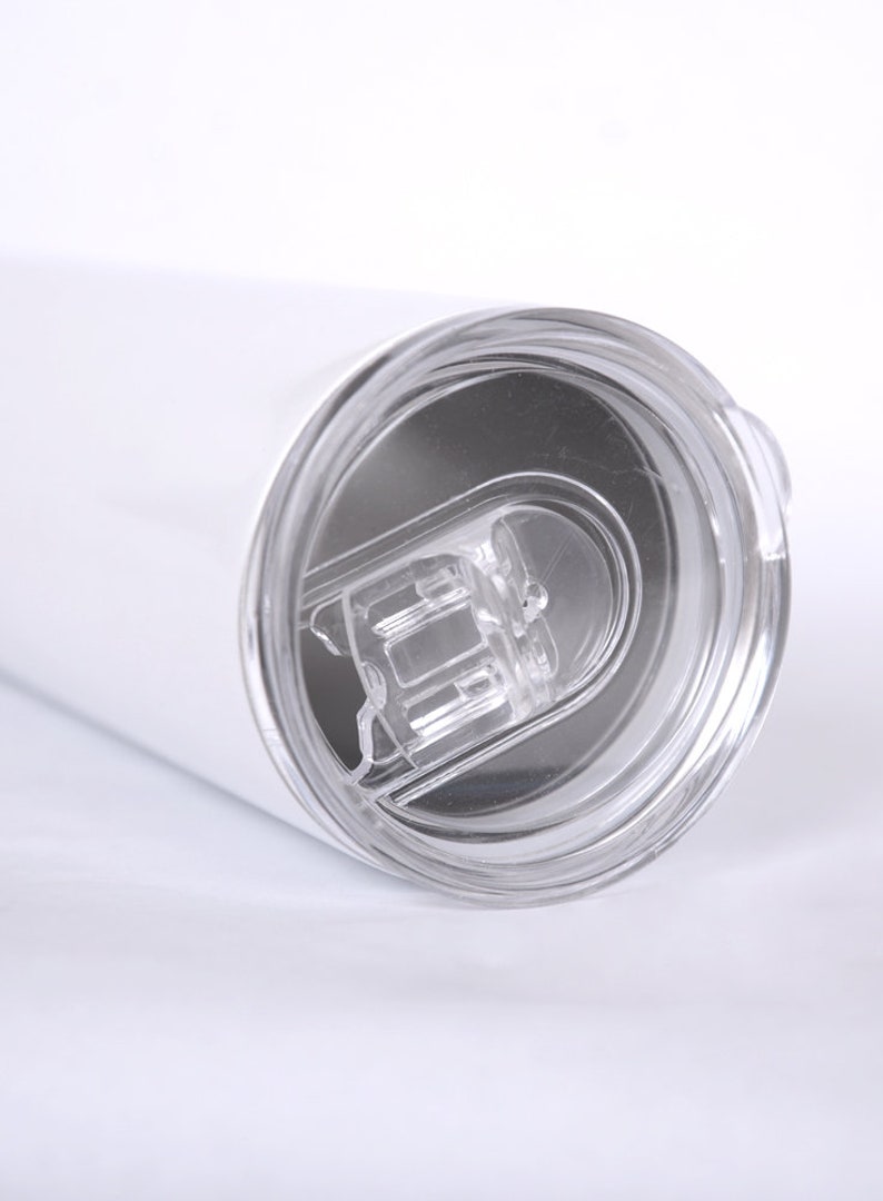 May include: White stainless steel tumbler with a clear lid. The lid has a small opening for sipping.