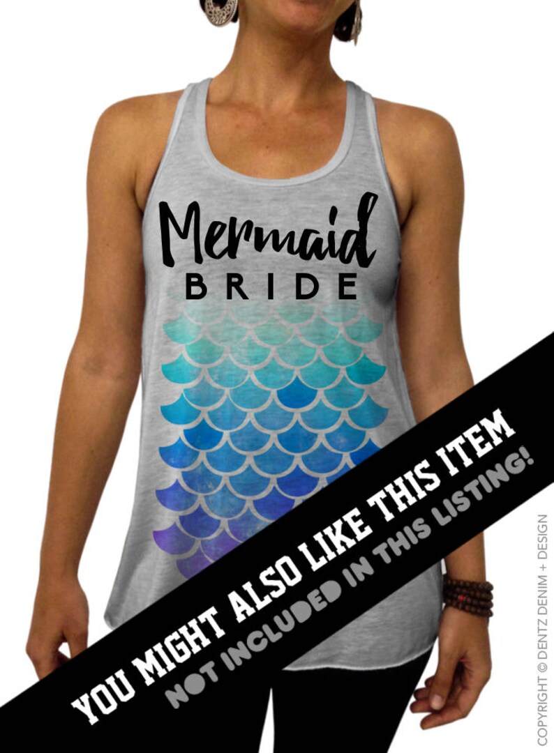 May include: A gray tank top with the words "Mermaid BRIDE" in black script. Below the text is a mermaid scale design in shades of blue and purple. The tank top is a bridal themed item.