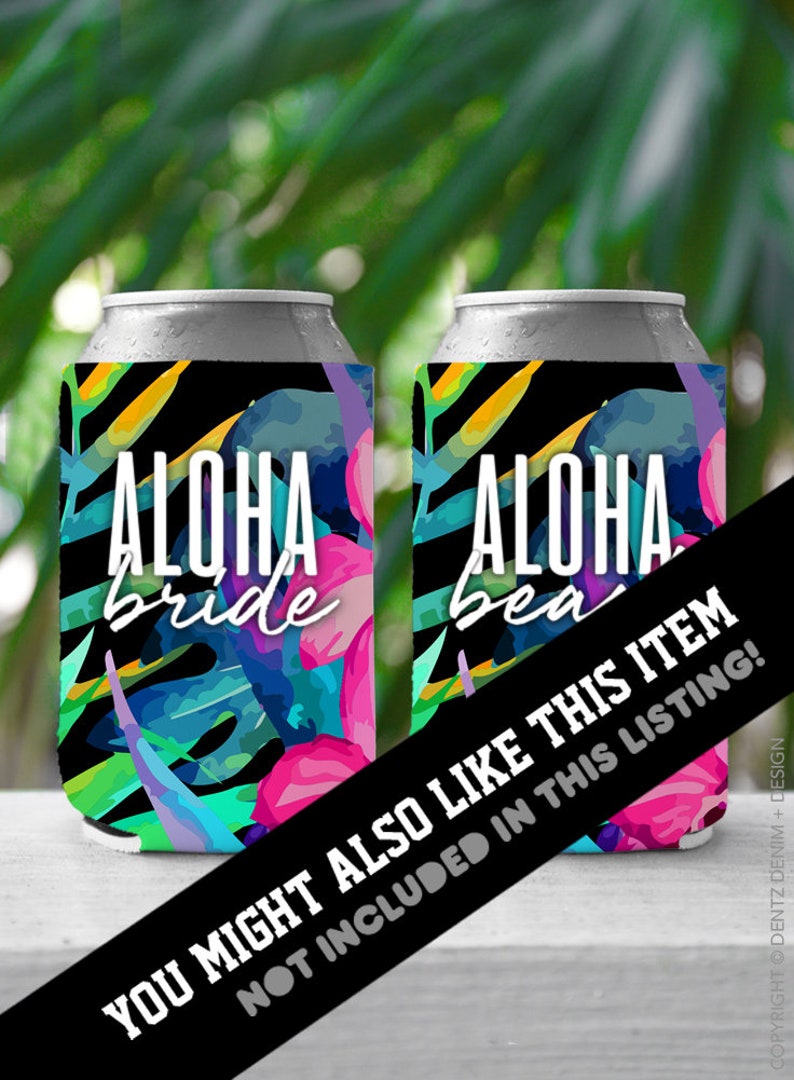 May include: Two silver can coolers with a tropical design. The coolers feature the words "ALOHA bride" and "ALOHA bea" in white script. The design includes pink, blue, and green tropical leaves and flowers against a black background.