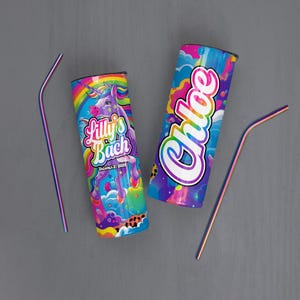 May include: Two colorful insulated tumblers with lids and rainbow straws. One tumbler features a unicorn design with the text "Lilly's Bach" and "October 2, 2026". The other tumbler has the name "Chloe" in a rainbow font.