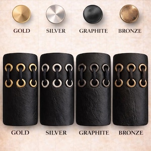 May include: Image showcasing hardware finish options: gold, silver, graphite, and bronze. Each finish is displayed on a round knob and a black leather cuff with decorative eyelets. Text reads "CHOOSE YOUR HARDWARE FINISH:"