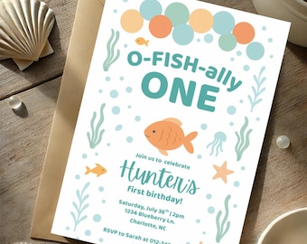 May include: A birthday invitation with an aquatic theme. The invitation features the text "O-FISH-ally ONE" and "Hunter's First birthday!" in teal and orange. The design includes illustrations of fish, bubbles, seaweed, and starfish. The invitation is on a white background.