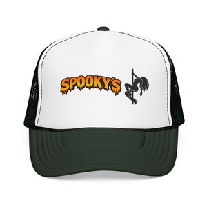 May include: A black and white trucker hat with a dark green brim. The hat features the word "SPOOKY'S" in orange dripping letters, and a black silhouette of a person pole dancing.