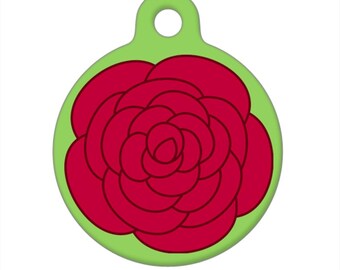 May include: A green and red round pet tag with a stylized red rose design.