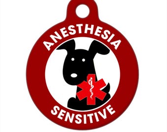 May include: Red round dog tag with white text that reads "Anesthesia Sensitive". A black cartoon dog is holding a red medical symbol with a snake wrapped around a staff.
