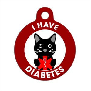 May include: Red round pet ID tag with a black cat holding a red medical symbol with a snake. The tag says "I HAVE DIABETES" in white text.