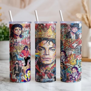 May include: Three cylindrical tumblers with white straws, featuring a colorful graffiti-style collage of Michael Jackson. The design includes portraits, musical instruments, and the text King of Pop, set against a vibrant, multi-colored background.