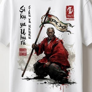 May include: A white t-shirt featuring a graphic of an older person in a red robe and black pants, kneeling while holding a staff with a flag depicting broken chains. The design includes the text Siku ya Uhuru, 1865 Juneteenth, and Juneteenth 1865.