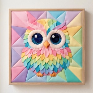 May include: A square wall art piece featuring a layered fabric owl with large dark eyes and a pointed orange beak. The owl is composed of multi-coloured petal-shaped fabric pieces in pastel hues, set against a geometric background of triangles.