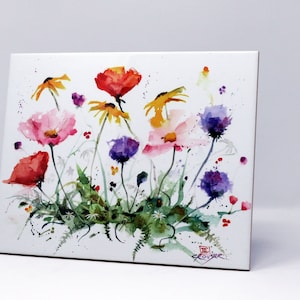 May include: A watercolor painting of colorful wildflowers, including red poppies, yellow coneflowers, and purple thistles, on a white background. The artwork features a variety of blooms and green foliage, with a signature in the lower right corner.