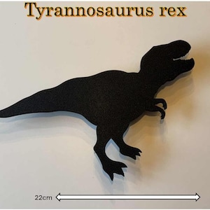 May include: A black Tyrannosaurus rex silhouette, 22cm long and 15cm tall, against a white background. The text "Tyrannosaurus rex" is displayed above the dinosaur. The dinosaur's form is detailed, with visible teeth and claws.