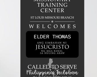 May include: A monochrome poster with text including "The Missionary Training Center" and "St Louis Missouri Branch". It welcomes "Elder Thomas" and mentions "Ang Simbahan Ni Jesucristo". It also says "Called to Serve Philippines Tacloban Tagalog Speaking".