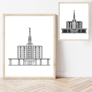 May include: Two framed black and white architectural prints. The prints depict a detailed line drawing of a building with a tall spire and a statue on top. The frames are light brown.