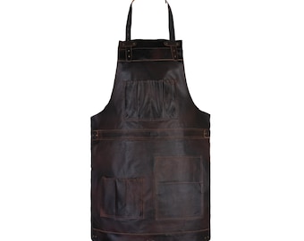 May include: A dark brown leather apron with multiple pockets and a leather neck strap. The apron has a rustic, worn appearance with visible stitching and rivets. The apron is designed for use in the kitchen or workshop.