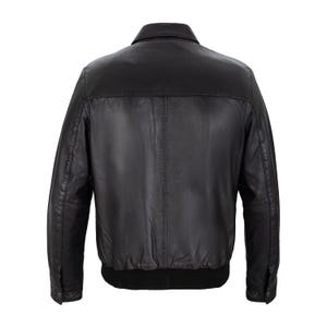 May include: A black leather jacket featuring a classic collar, long sleeves with buttoned cuffs, and a ribbed knit hem. The back panel is constructed with a horizontal seam across the upper shoulders and a vertical seam running down the center.