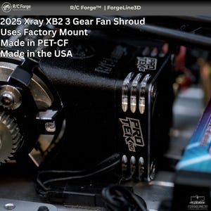 May include: A close-up of a black 2025 Xray XB2 3 Gear Fan Shroud for remote control parts. The shroud uses a factory mount and is made in PET-CF. The text "PRO TEK RC" is visible on the side. The product is made in the USA.