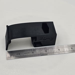 Part with ruler for size reference