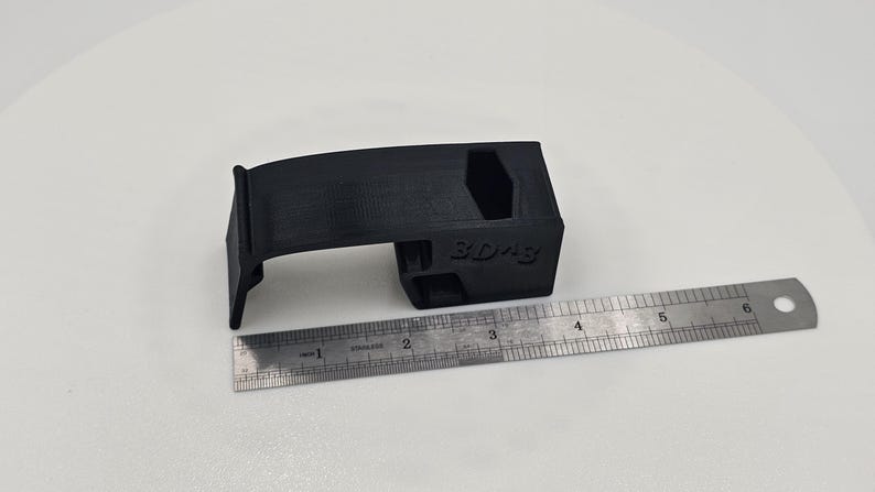 Part with ruler for size reference