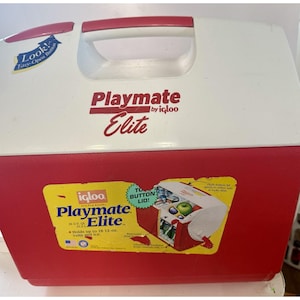 May include: A red and white Igloo Playmate Elite cooler with a white handle and a push-button lid. The cooler has a sticker that says "Holds up to 18 12-oz cans and ice."