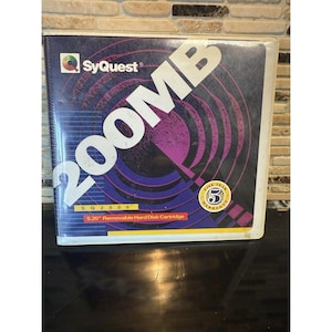 May include: A SyQuest SQ2000 5.25" removable hard disk cartridge. The cover features the text "200MB" in large white letters, with the SyQuest logo and a five-year warranty seal. The background is a gradient of purple and blue.