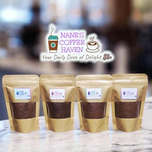May include: Four sealed brown paper bags of ground coffee are displayed. Each bag has a clear window showing the dark coffee grounds and a label that reads "Nane's Coffee Haven" with a coffee cup graphic. The text "Your Daily Dose of Delight" is also visible.