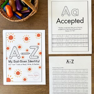 Puede incluir: Hojas de trabajo educativas con el alfabeto y las palabras "Accepted" y "My God-Given Identity!" con un diseño de sol. También se ve una cesta de lápices de colores en varios colores.