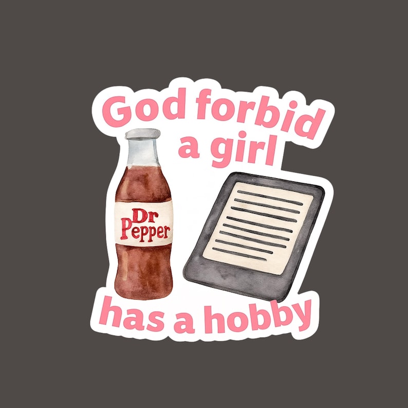 May include: A sticker featuring a Dr. Pepper bottle and an e-reader. The text "God forbid a girl has a hobby" is written in pink. The background is a solid dark gray.