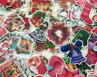 May include: A collection of colorful Christmas-themed stickers. The stickers feature various holiday images, including a gingerbread man, Christmas trees, Santa hats, wreaths, and stockings. The stickers are in various shapes and sizes.