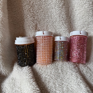 May include: A white ceramic mug with a black handle and the text "But First, Coffee" in a handwritten style. The mug is on a white surface. The mug is approximately 4 inches tall.