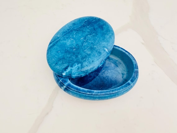 A swivel-lidded box carved from solid turquoise-hued alabaster stone — weighty, cool to the touch, and genuinely one-of-a-kind as a natural material object.