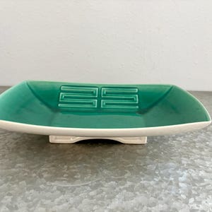 May include: A set of three ceramic mugs with a speckled, matte finish. The mugs are in shades of cream, light gray, and dark gray. Each mug has a simple, minimalist design, perfect for coffee or tea.