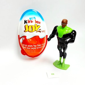 May include: A Kinder Joy egg with blue, white, and red packaging, and a Green Lantern action figure. The egg has text in Hebrew. The Green Lantern figure is black and green.