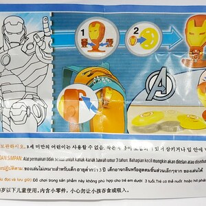 May include: A colorful package featuring Iron Man from Marvel's Avengers. The package includes illustrations of Iron Man, assembly instructions, and the Avengers logo. The package also has text in multiple languages.