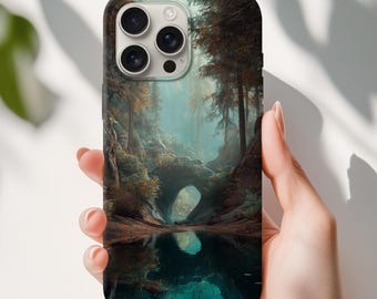 May include: A smartphone case featuring a scenic landscape of a forest with a lake. The design showcases a misty, ethereal scene with trees, a natural arch, and a reflective body of water. The case has a glossy finish and a camera cutout.