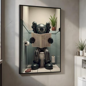 May include: Framed artwork depicting a black cartoon figure with X eyes, reading a newspaper on a toilet. The figure is dressed in striped trousers and black shoes. The artwork is set in a bathroom with a toilet, toilet roll, and a potted plant.
